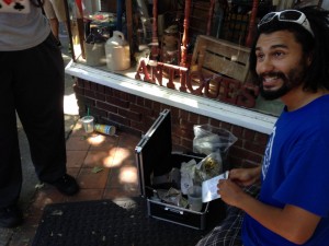 Adam Alexander, from the illegal Grow Systems Northwest, handed out free samples of his home-grown pot outside Main Street Marijuana on its opening day.