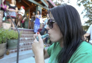 (Amanda Gloudeman smokes a pipe with marijuana Saturday night at Mint Tea on Main Street in Vancouver.  -Natalie Behring)