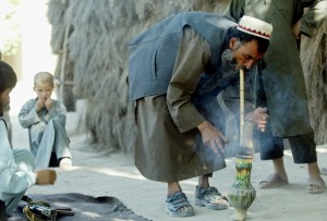 (A farmer smokes hashish near the northern Afghan city of Mazar-e-Sharif on Sept. 11, 2002. Many people in the region grow illegal cannabis to smoke or export. -MINDAUGAS KULBIS/Associated Press)
