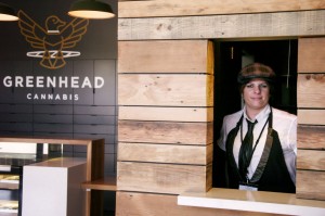Amy Graeff, GreenHead's managing director, stands at the speakeasy window.