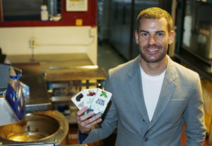 Andrew Schrot, chief executive officer of BlueKudu, shows off some of the candy bars prepared in the kitchen of the marijuana-infused candy maker in the historic Five Points District of Denver. (David Zalubowski/Associated Press)