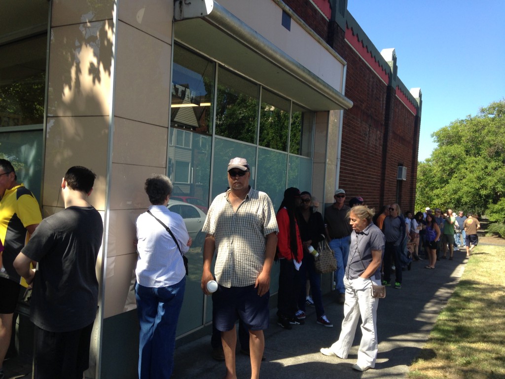 (Customers wait on day 2 outside Main Street Marijuana)