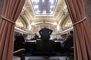 (House Speaker Pro Tempore Jim Moeller, D-Vancouver, looks out over the House Chamber moments before the start of a 30-day special session of the Legislature on Wednesday in Olympia. -Elaine Thompson/AP)