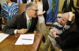 (Haiden Day, 6, second from right, who has Dravet Syndrome, a form of epilepsy that his father, Ryan Day, right, says is best treated with medical marijuana, talks with Washington Gov. Jay Inslee, left, before Inslee signed a bill Friday at the Capitol in Olympia that overhauls Washington's medical marijuana market. The bill also creates a voluntary database of patients and cracks down on unregulated dispensary sales. Inslee has said the measure is needed now that the state's voter-approved recreational market is in place. -AP Photo/Ted S. Warren)