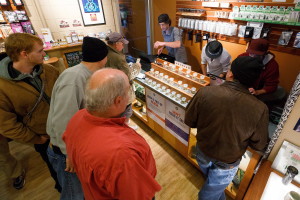 Employees of Amazon Organics, a pot dispensary in Eugene, Ore., help customers purchase recreational marijuana on Thursday. Oregon marijuana shops began selling marijuana Thursday for the first time to recreational users who are at least 21 years old, marking a big day for the budding pot industry. (AP Photo/Ryan Kang)