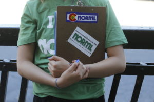 A marijuana reform advocate with the group NORML holds a clipboard while waiting for passersby to sign a petition to get a pot club initiative on the ballot in the next election, in Denver. Legal marijuana is giving Colorado a stinky conundrum. (AP Photo/Brennan Linsley)