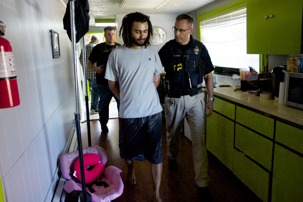 A warrant is served at the home of Adam Alexander, owner of Grow Systems Northwest, onThursday. Alexander made a first appearance Monday in Clark County Superior Court on suspicion of 14 counts of possession of marijuana with the intent to deliver, three counts of manufacturing marijuana and money laundering. (Steven Lane/The Columbian)
